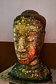 Ayutthaya, Thailand. Viharn Phra Mongkhon Bophit, Buddha heads covered in gold leaves. 